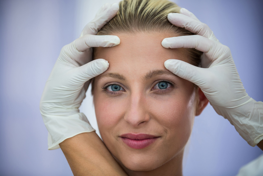 doctor-examining-female-patients-face-from-cosmetic-treatment (3).jpg